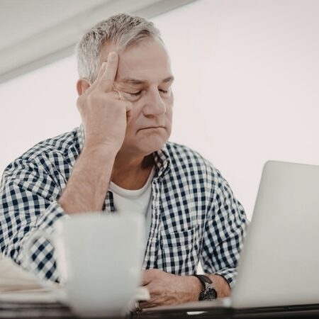 Retiree reviewing IRA distribution strategies on a laptop for tax-smart retirement planning