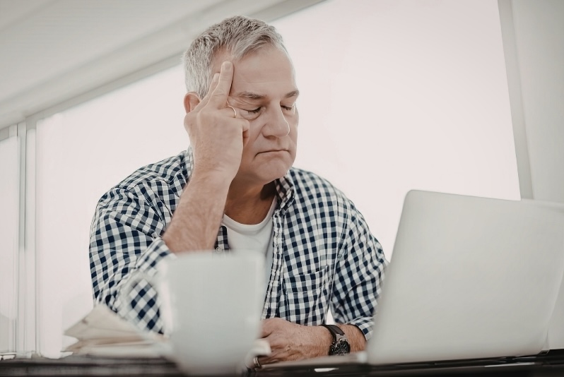 Retiree reviewing IRA distribution strategies on a laptop for tax-smart retirement planning